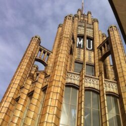 Looking up at the gothic-revival facade and tower of the Manchester Unity Building in Melbourne