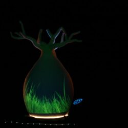 Carved polystyrene baobab sculpture in green projection light, Babbling with Baobabs, Melbourne International Comedy Festival 2019