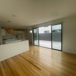 Open-plan living and work space with timber floors at Oddtoe’s home office in Brunswick, Melbourne