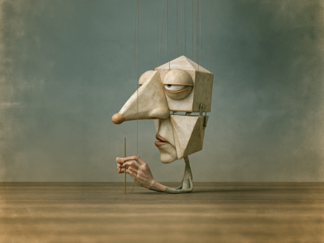 Marionette with a hinged jaw hanging on strings, a hand below holding a control stick